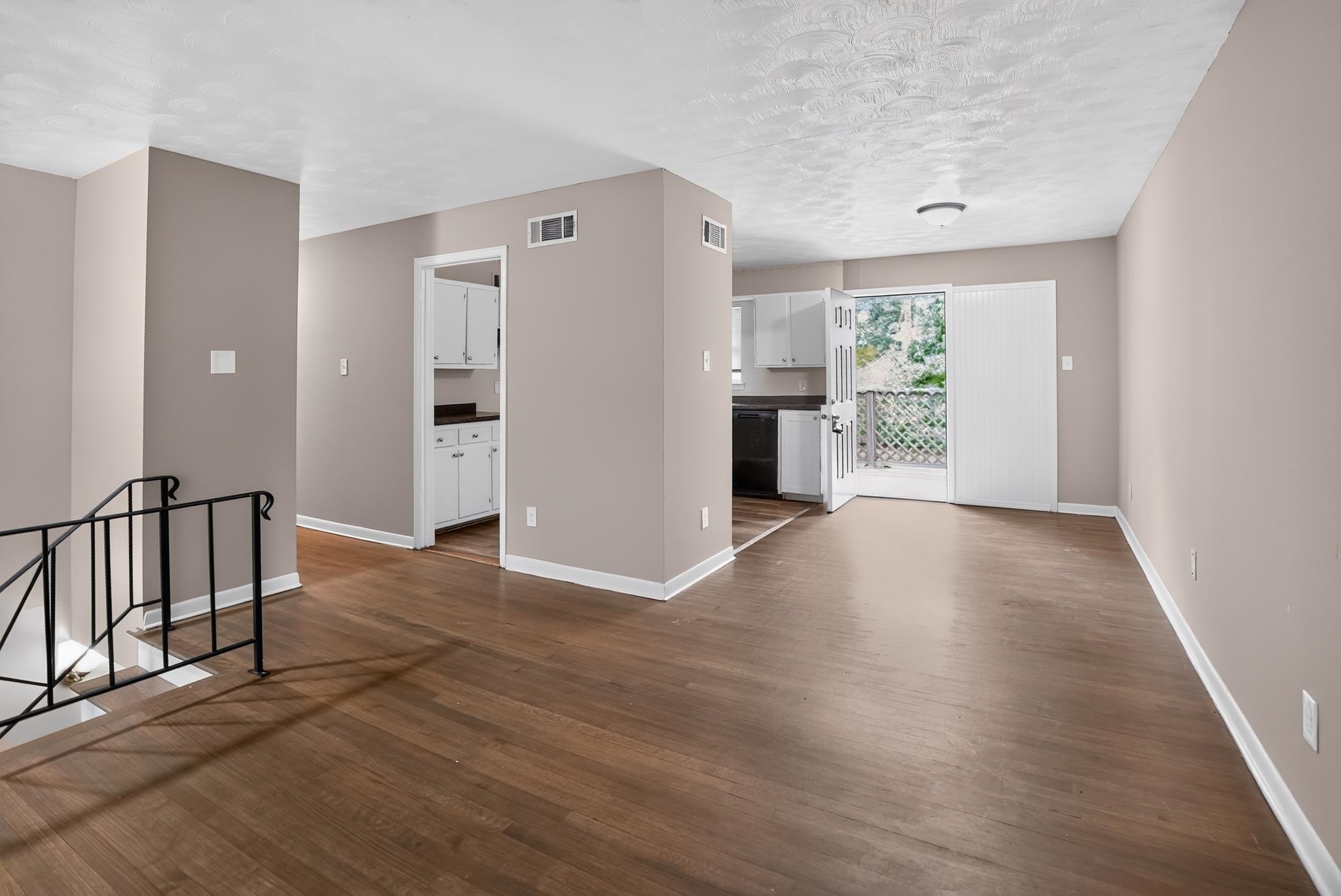 3391 South Perkins Road Memphis, TN 38118 - Photo 6 of 16 Open-concept living area featuring wood-finish flooring, neutral wall tones, and white baseboards