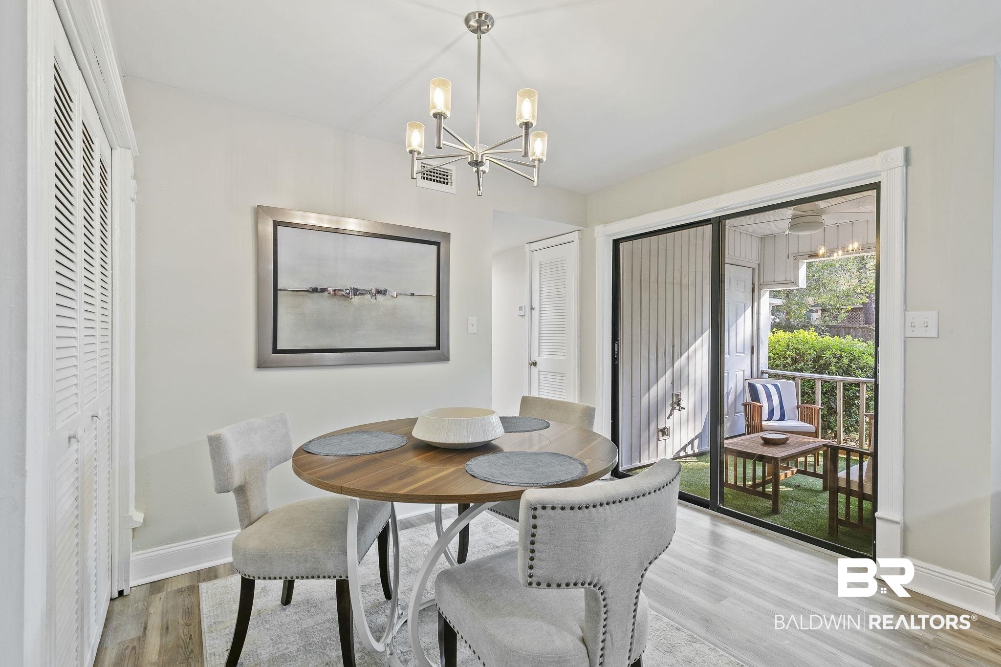 110 5th Street, Unit C103 Daphne, AL 36526 - Photo 12 of 46 Dining space featuring a notable chandelier and light hardwood / wood-style flooring