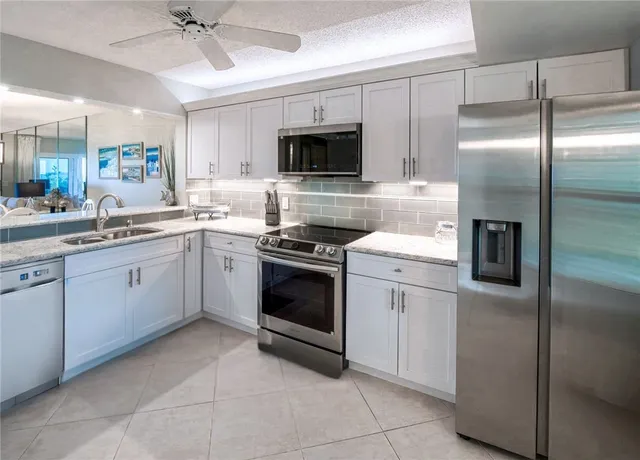 a kitchen with sink and cabinets