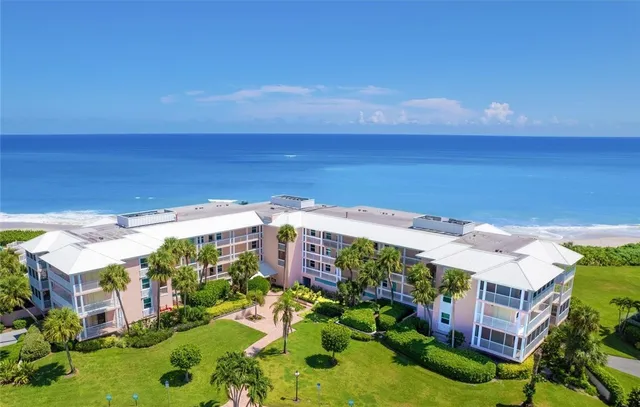 a view of a patio with a table chairs and wooden floor