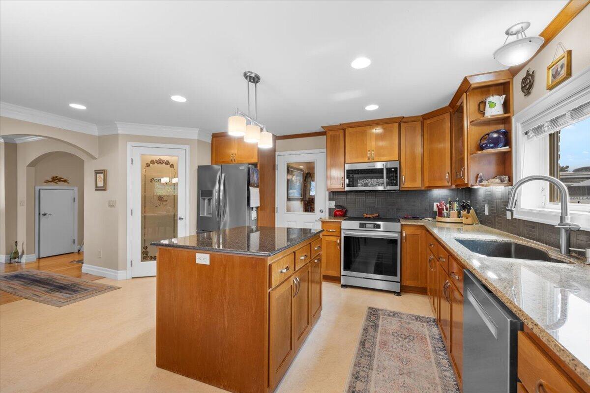 440 Bush Street Central Point, OR 97502 - Photo 17 of 40 a kitchen with stainless steel appliances granite countertop a sink and a stove