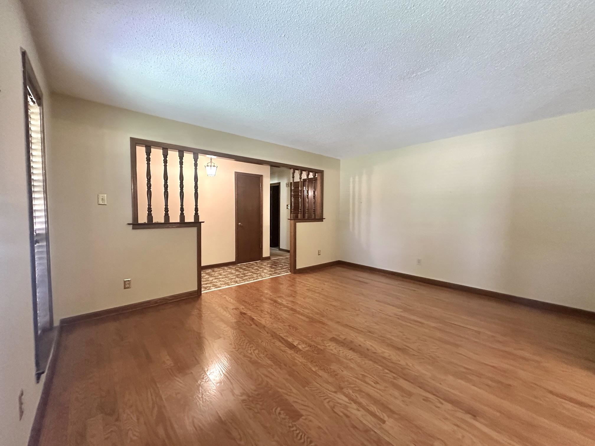 3489 Evening Light Drive Bartlett, TN 38135 - Photo 11 of 30 an empty room with wooden floor and windows
