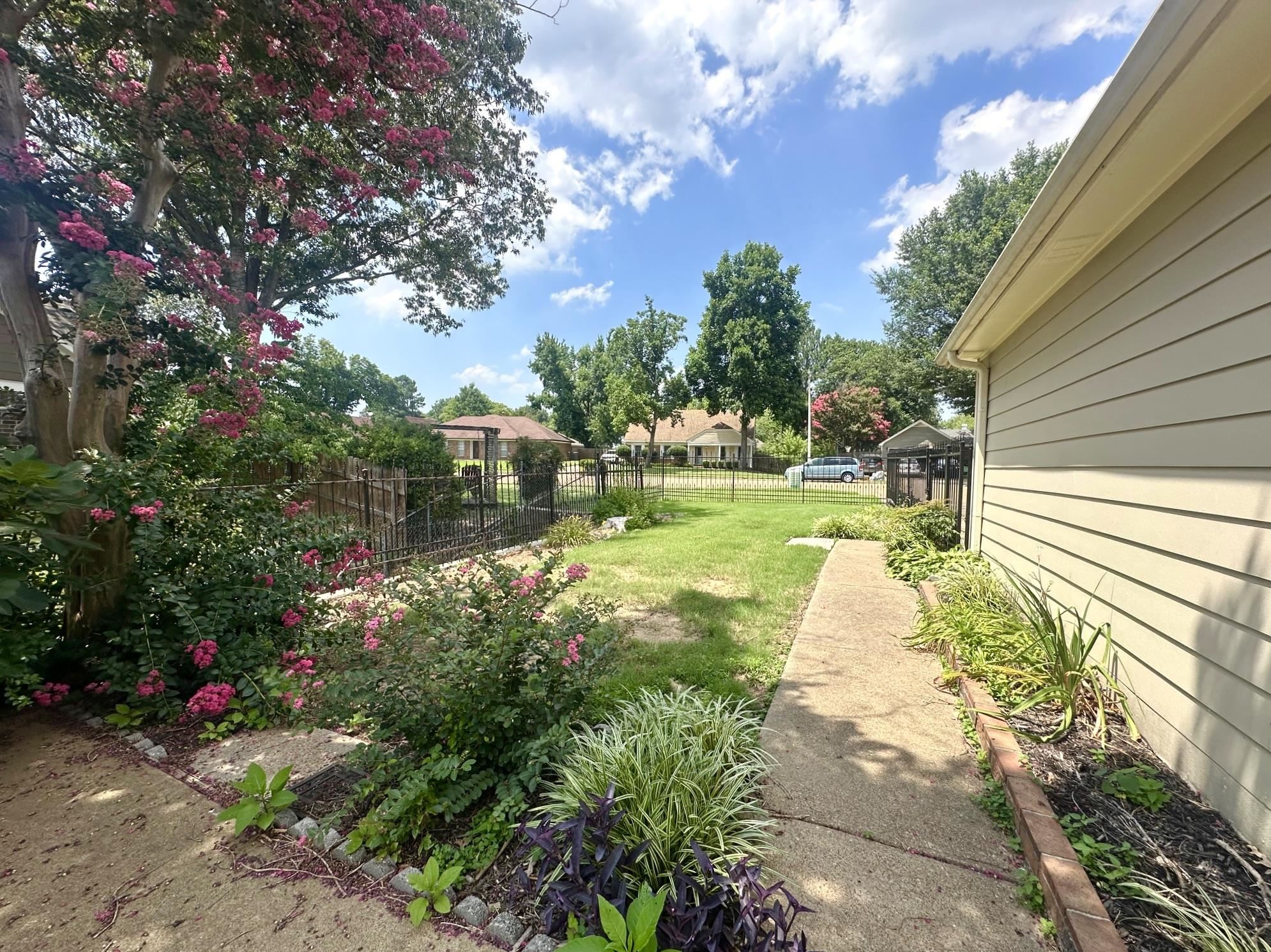 3489 Evening Light Drive Bartlett, TN 38135 - Photo 25 of 30 a view of a yard with flower plants