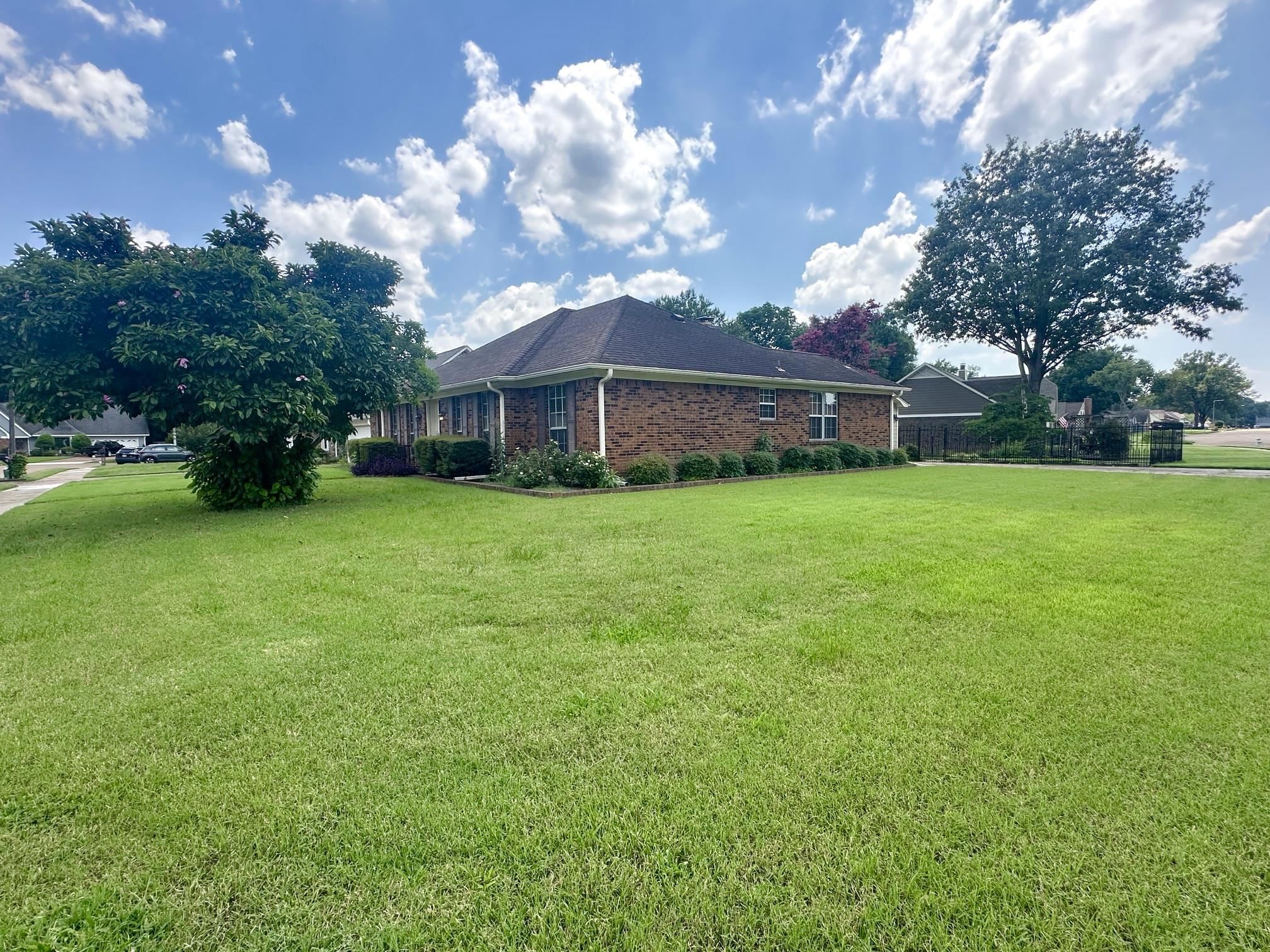3489 Evening Light Drive Bartlett, TN 38135 - Photo 3 of 30 a view of a house next to a big yard with large trees