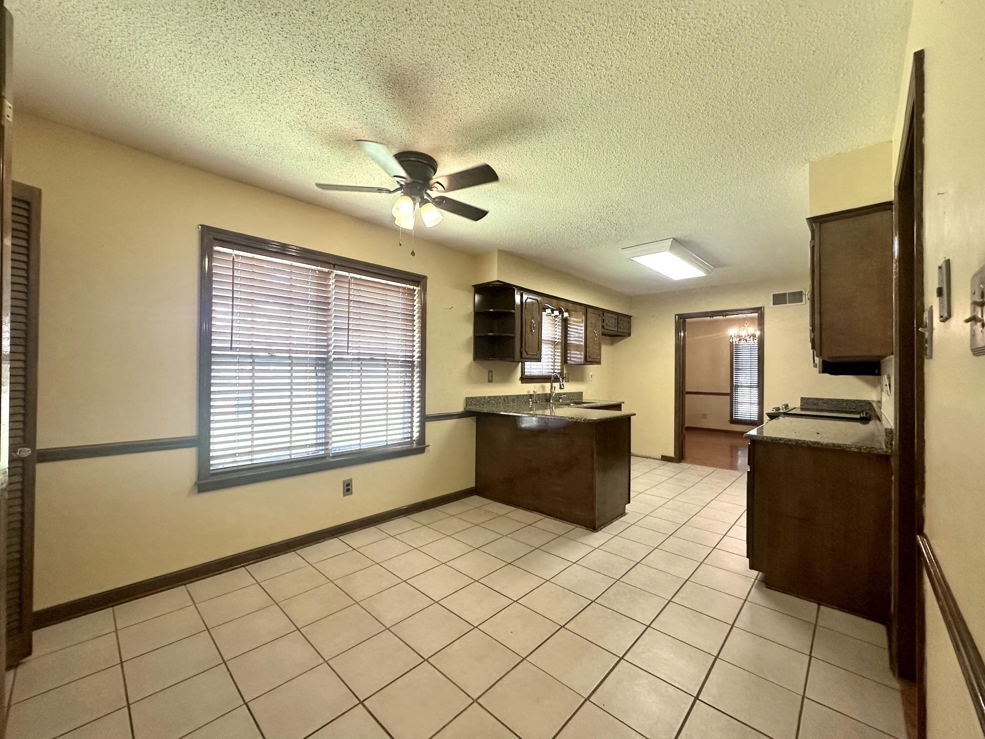 3489 Evening Light Drive Bartlett, TN 38135 - Photo 6 of 30 a large kitchen with stainless steel appliances a refrigerator and a stove top oven