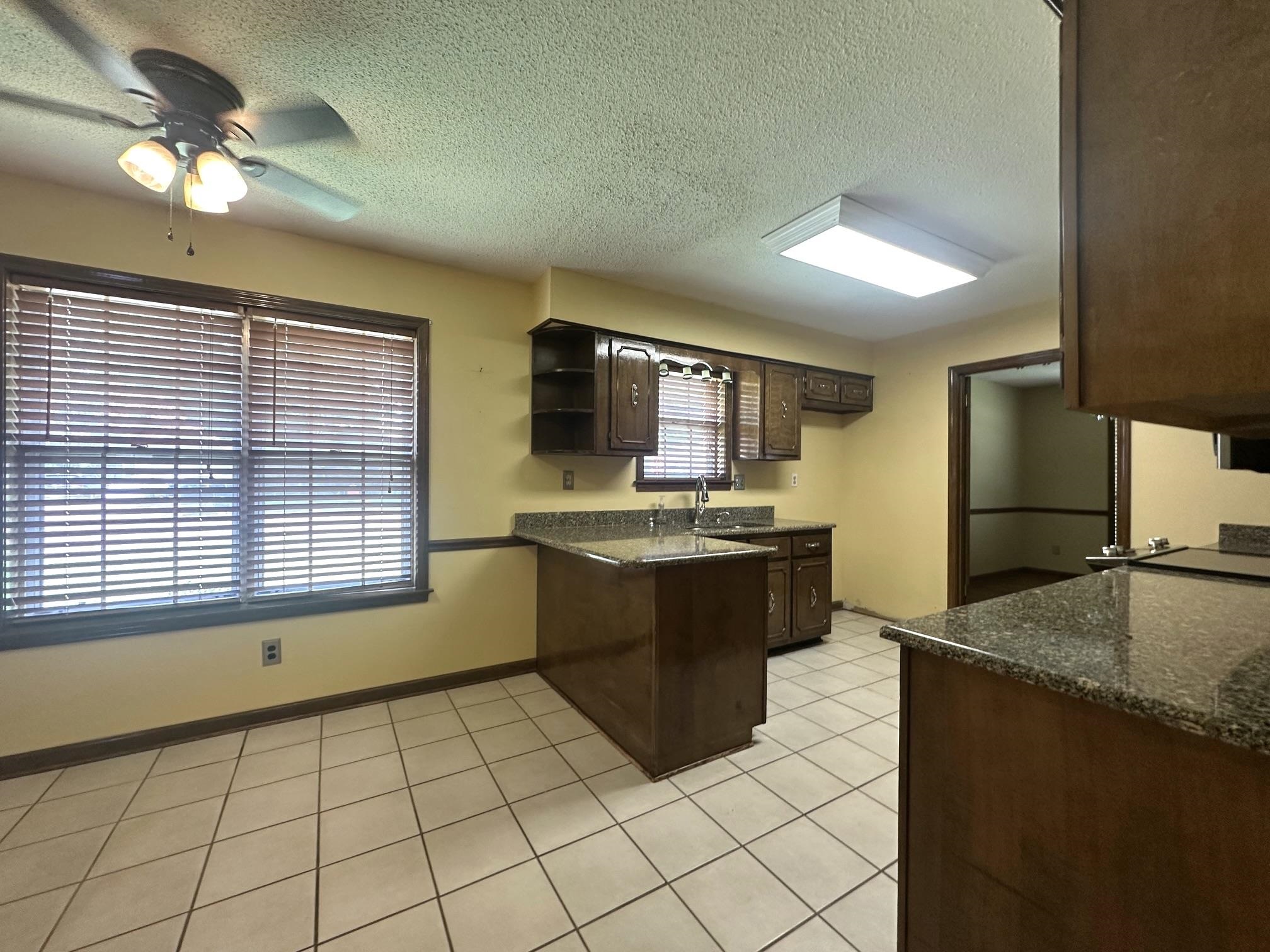 3489 Evening Light Drive Bartlett, TN 38135 - Photo 7 of 30 a large kitchen with a stove a sink dishwasher and a refrigerator