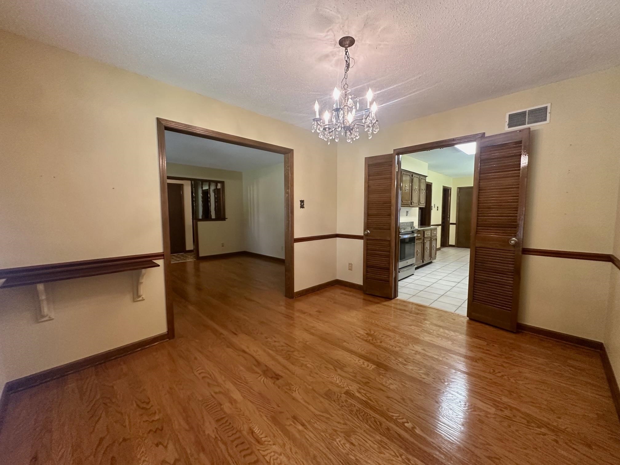 3489 Evening Light Drive Bartlett, TN 38135 - Photo 8 of 30 a view of a hallway with wooden floor and a kitchen