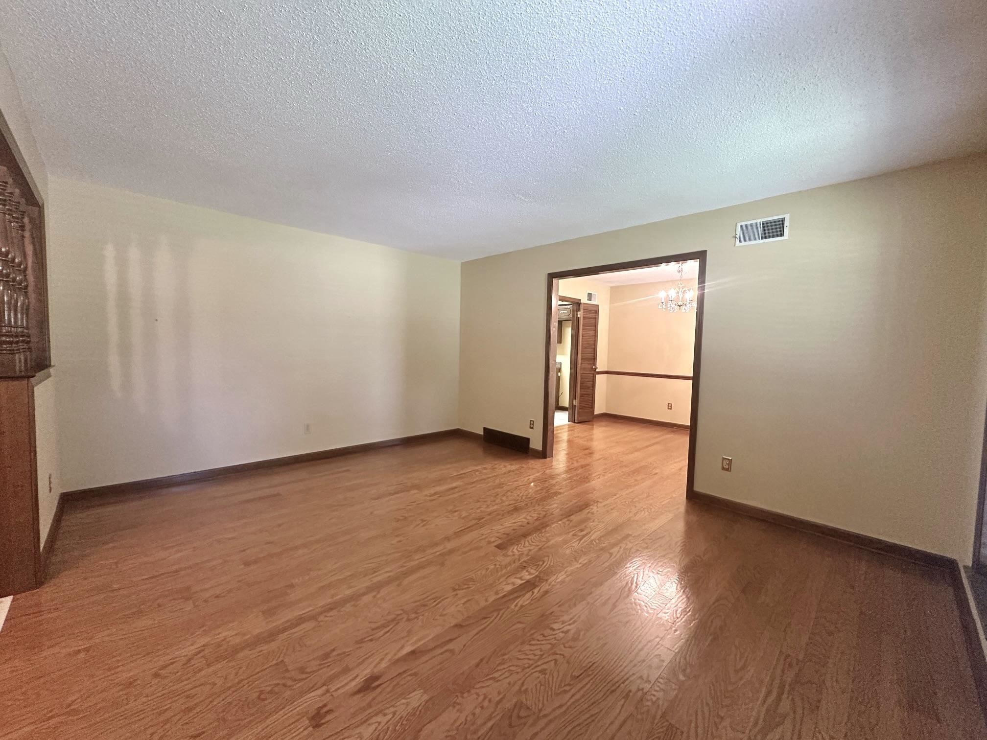 3489 Evening Light Drive Bartlett, TN 38135 - Photo 10 of 30 a view of an empty room with wooden floor and a window