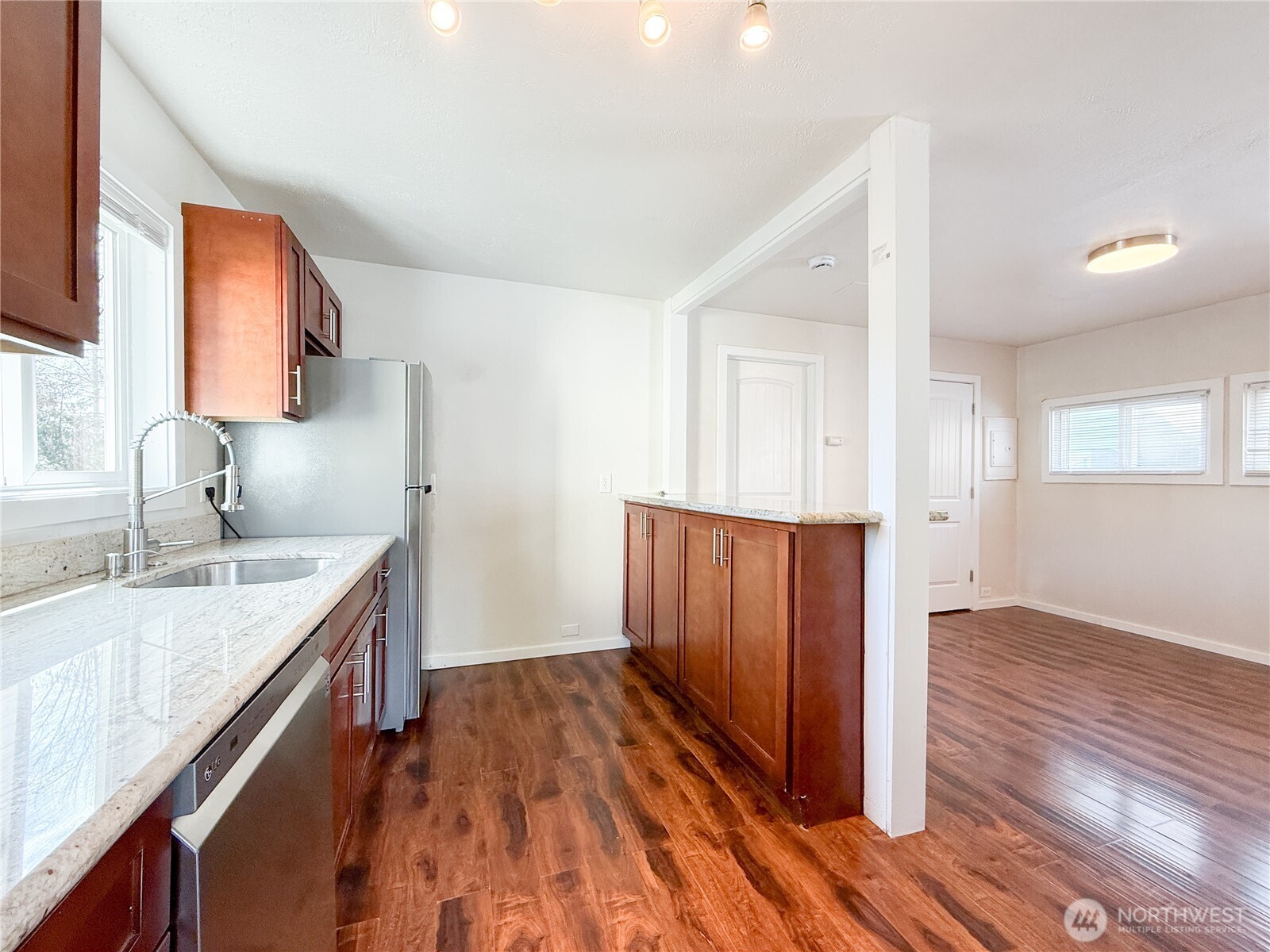 11806 Glendale Way South, Unit AB&C Seattle, WA 98168 - Photo 2 of 16 a kitchen with a sink and wooden floor