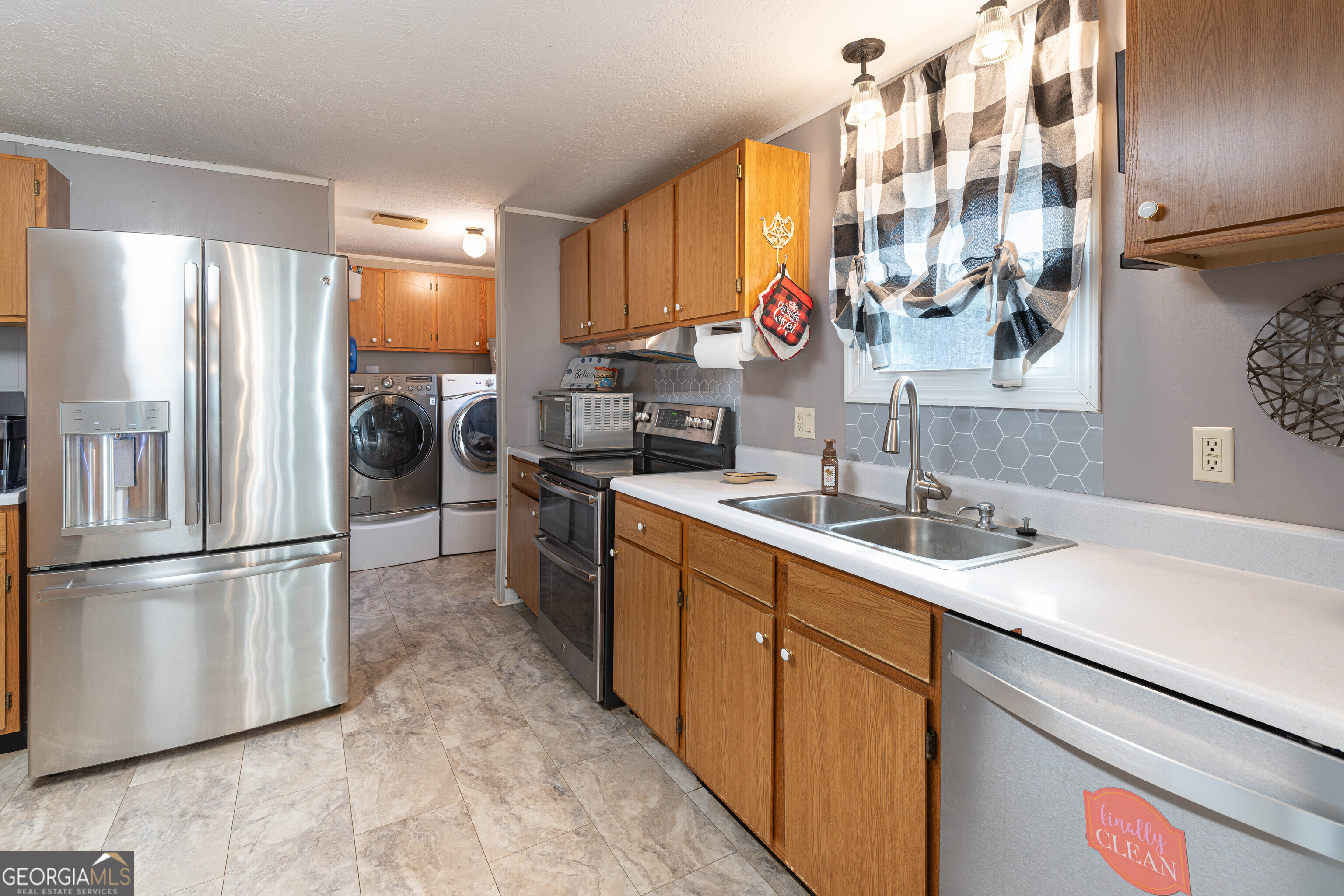 161 Cherokee Trail Forsyth, GA 31029 - Photo 11 of 32 a kitchen with refrigerator cabinets and a sink