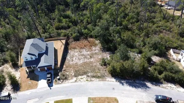 an aerial view of a backyard with swimming pool