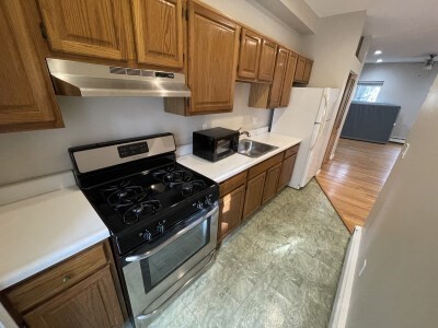 24 Pompeii Street, Unit 1 Boston, MA 02119 - Photo 1 of 10 a kitchen with granite countertop a stove and a sink