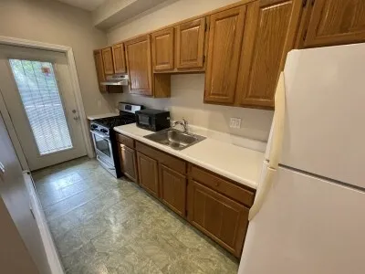 a kitchen with stainless steel appliances a refrigerator a sink a stove a microwave and cabinetry