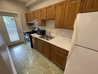 24 Pompeii Street, Unit 1 Boston, MA 02119 - Photo 2 of 10 a kitchen with stainless steel appliances a refrigerator a sink a stove a microwave and cabinetry