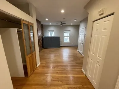 an empty room with closet and wooden floor