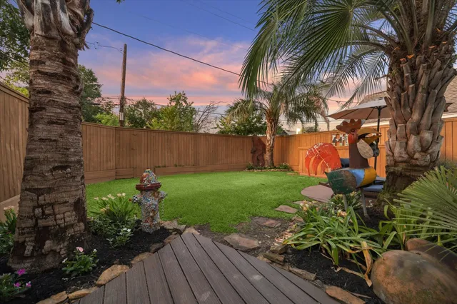 an aerial view of a house with garden space and street view