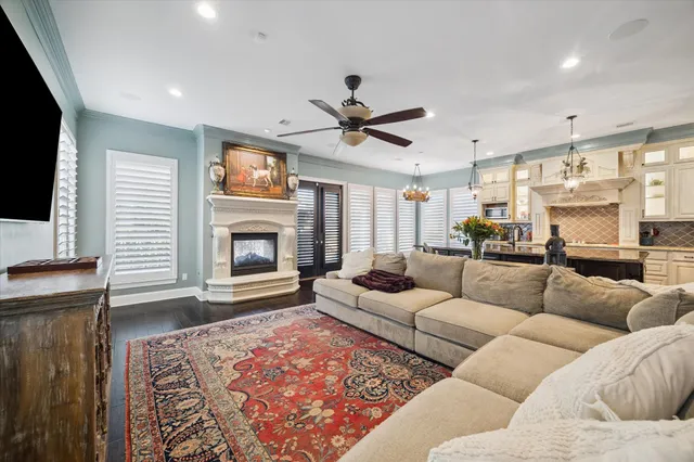 a living room with furniture a fireplace and a flat screen tv