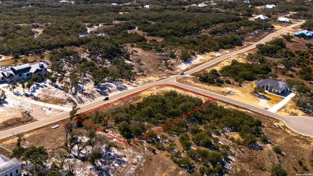 a view of a yard with wooden fence