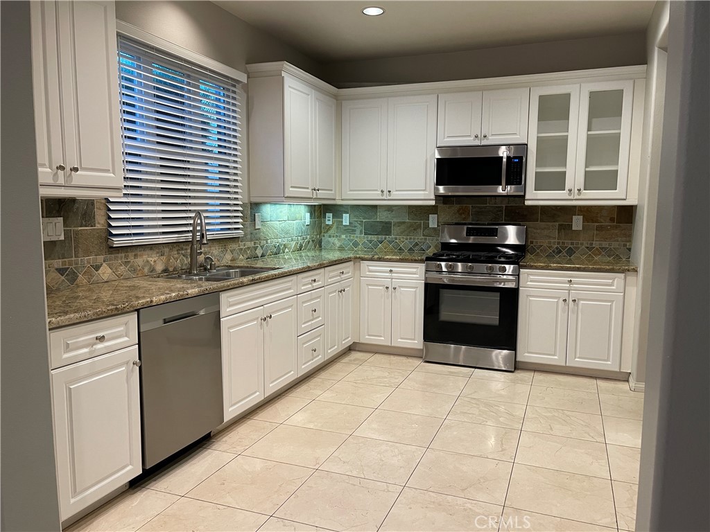 460 Santa Maria Street Anaheim, CA 92801 - Photo 2 of 5 a kitchen with stainless steel appliances granite countertop a stove sink and microwave