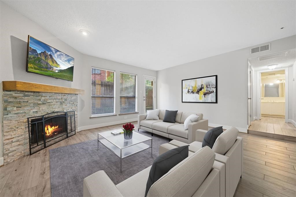 a living room with furniture and a fireplace