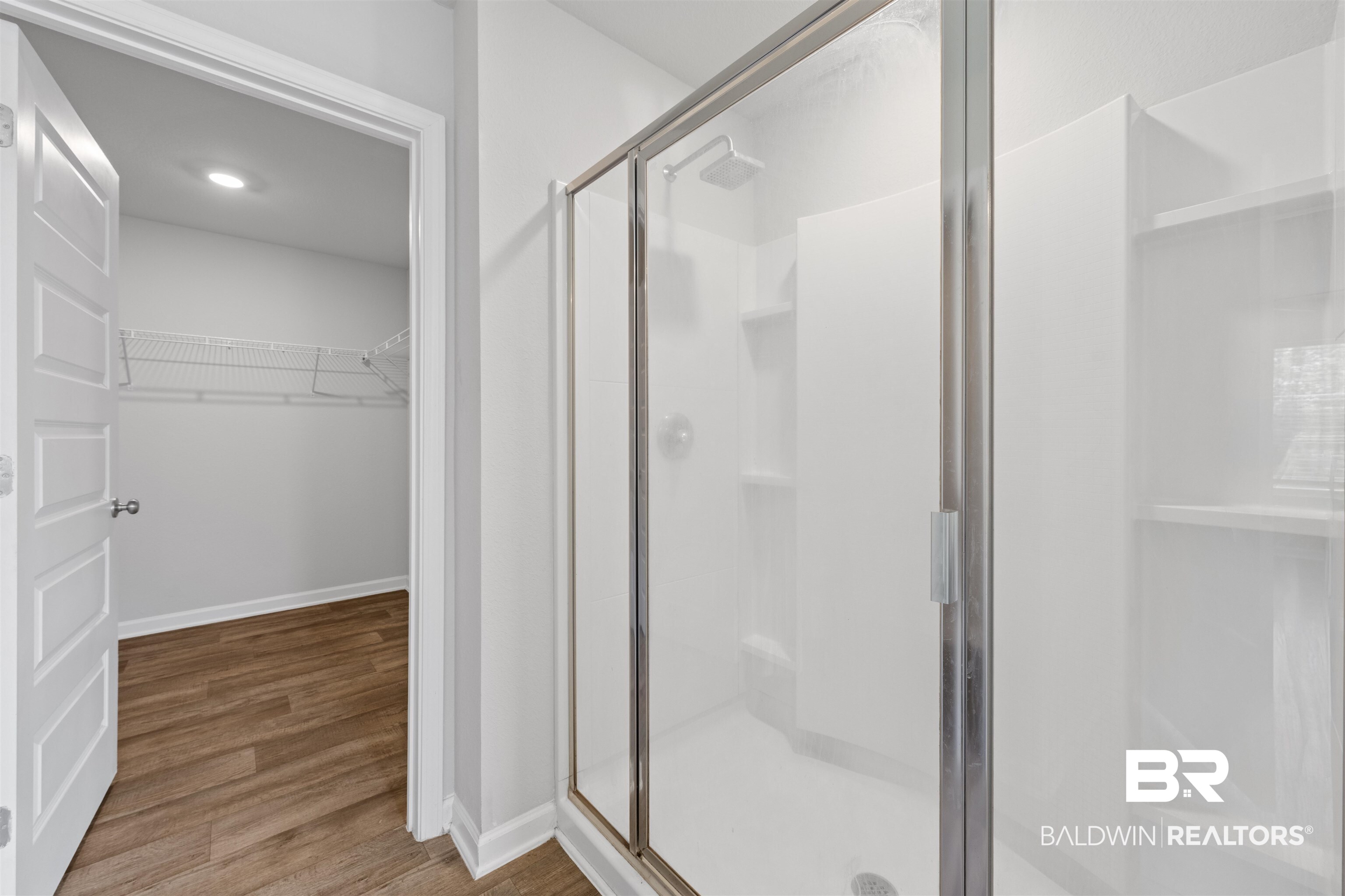 7457 Brompton Drive Foley, AL 36535 - Photo 13 of 24 Full bathroom featuring a walk in closet, a shower stall, light wood-type flooring, and recessed lighting