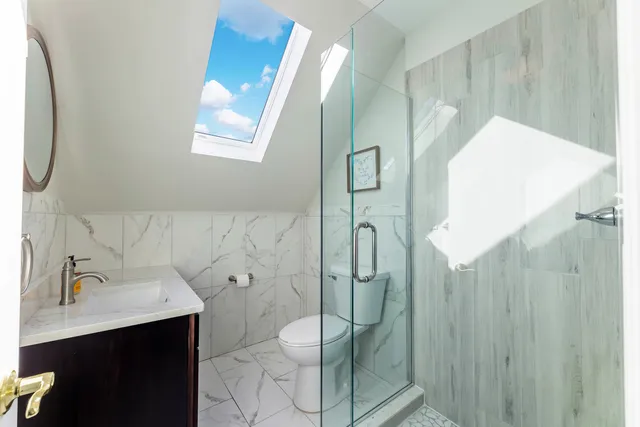 a bathroom with a sink mirror and toilet