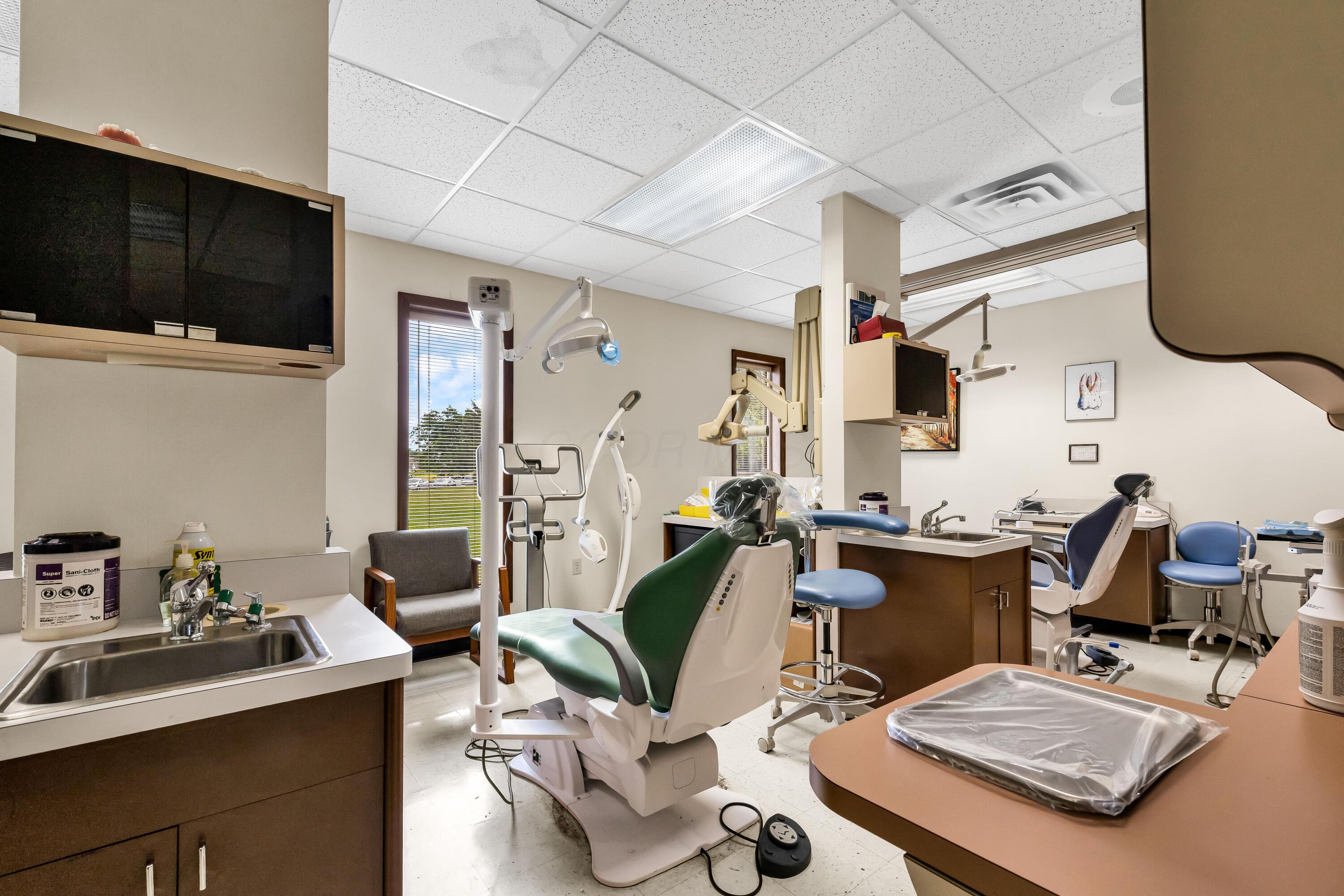 1240 Crescent Heights Road Marion, OH 43302 - Photo 37 of 60 • Neutral vinyl flooring • Ivory painted walls • Acoustic ceiling tiles • Fluorescent lighting • Enclosed vanity with single bowl, stainless steel sinktop • Divider • Lighting & equipment do not remain • Plumbed for oxygen & nitrogen