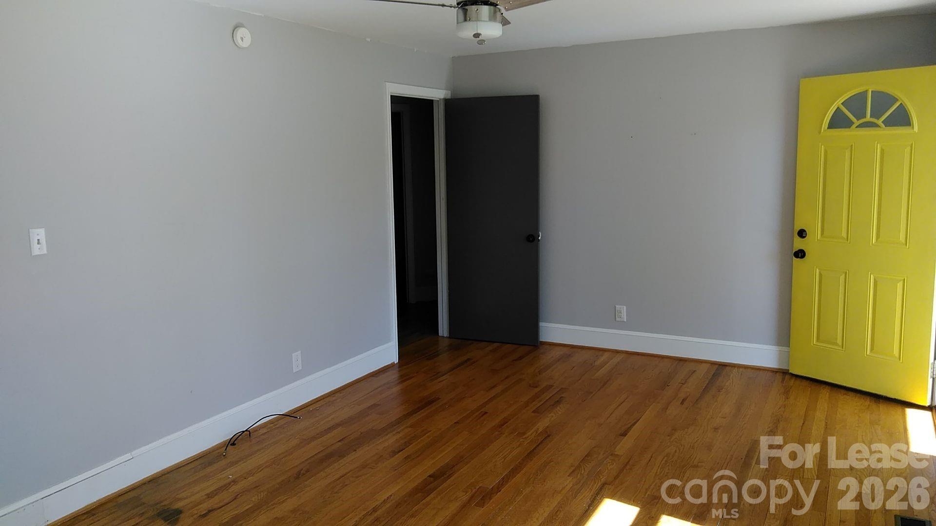 408 West Sandy Ridge Road Monroe, NC 28112 - Photo 11 of 11 a view of an empty room with window and wooden floor