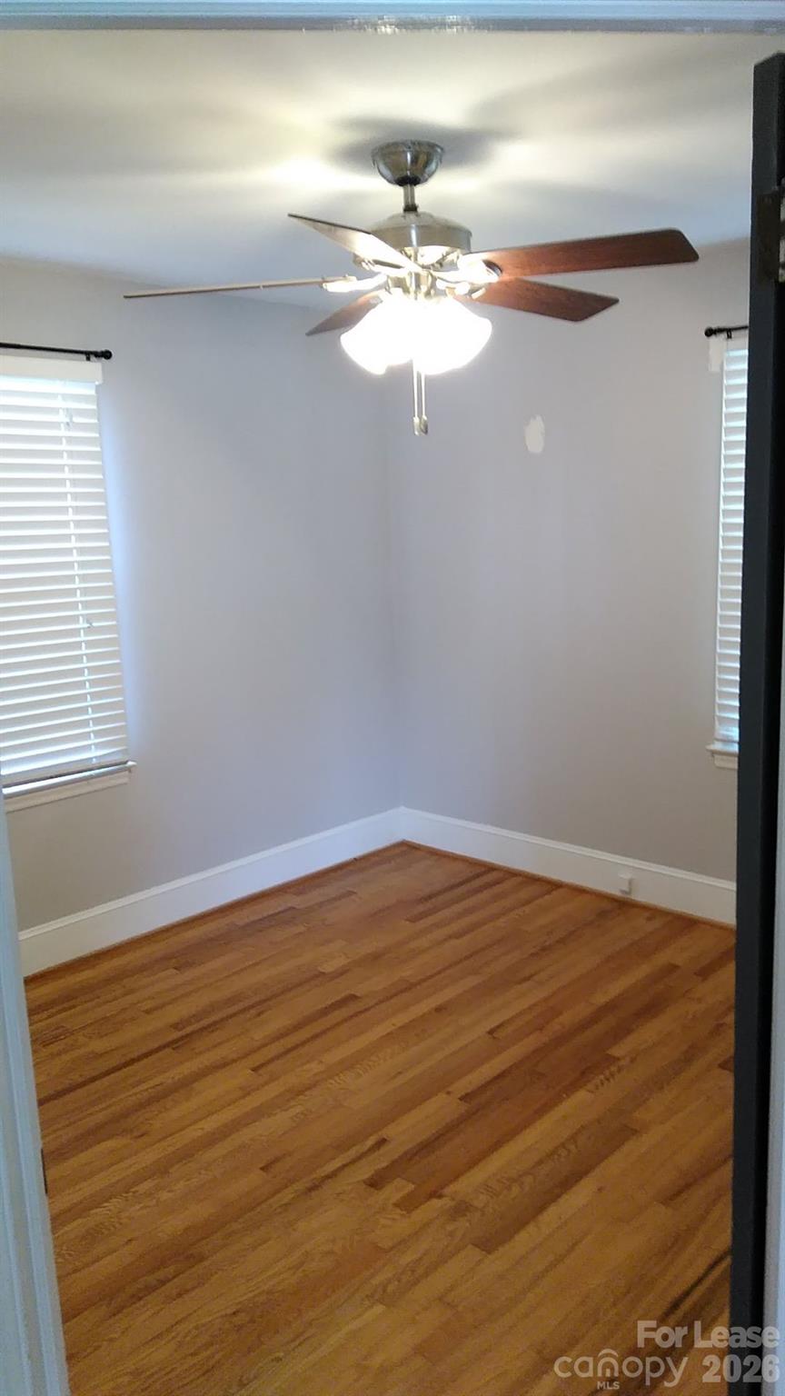 408 West Sandy Ridge Road Monroe, NC 28112 - Photo 3 of 11 a view of a room with wooden floor and a ceiling fan