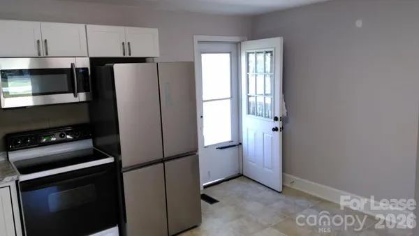 a kitchen with a refrigerator and a stove