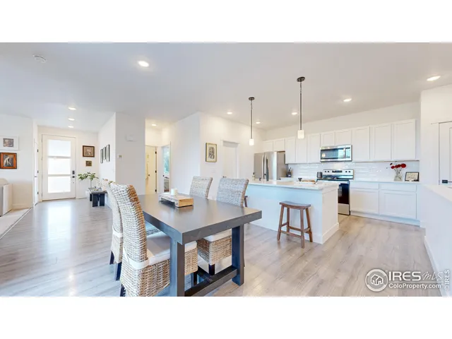 a kitchen with a table chairs refrigerator and cabinets