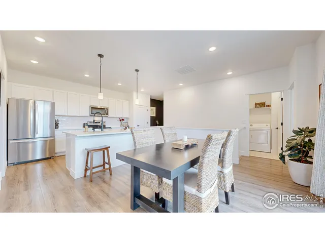 a kitchen with a table and chairs