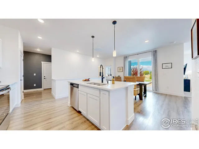 a open kitchen with sink and refrigerator