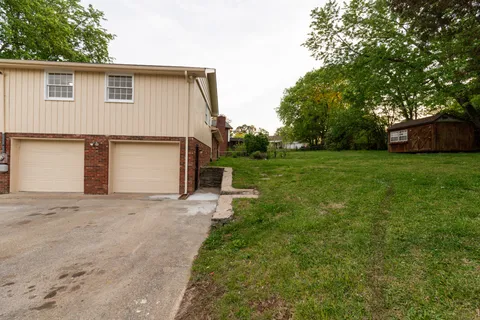a view of a house with a backyard