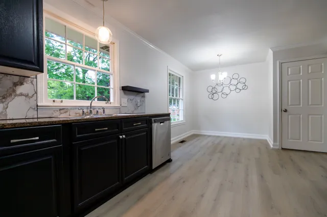 a kitchen with a sink cabinets and window