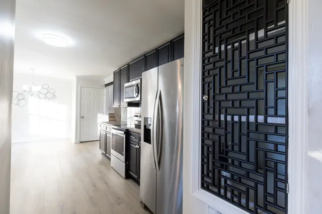 a kitchen with stainless steel appliances a refrigerator and a stove top oven