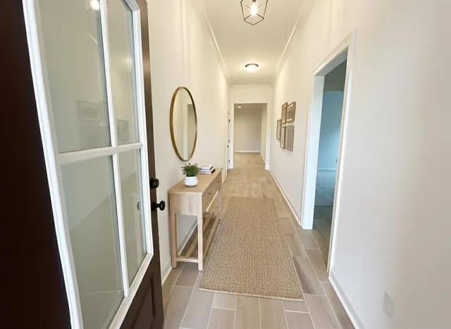 a view of a hallway with wooden floor