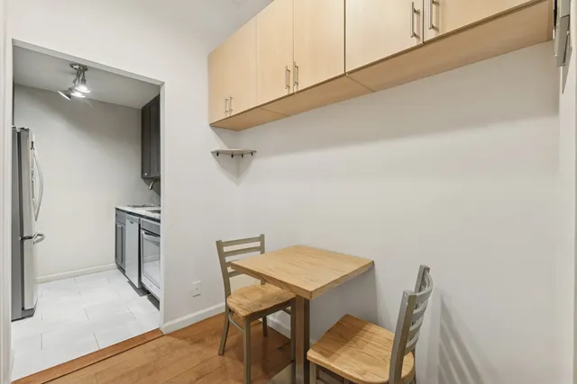 a view of a room with furniture and wooden floor