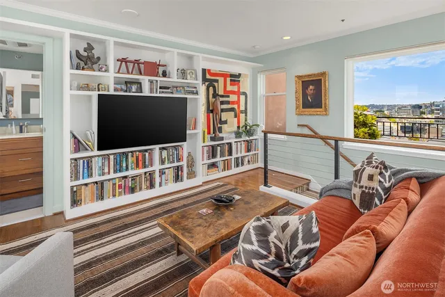 a view of a living room with furniture and a book shelf
