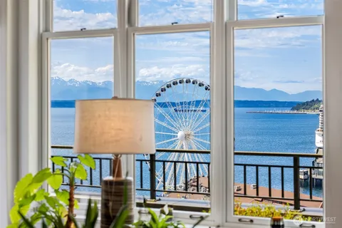 a view of a balcony with wooden floor and city view