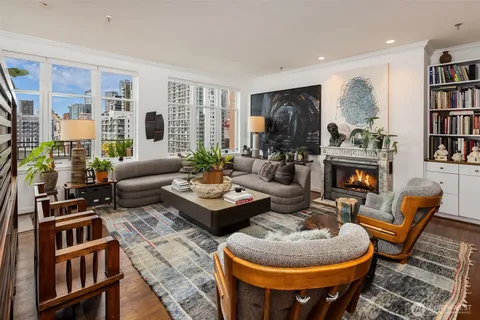 a living room with furniture and a potted plant