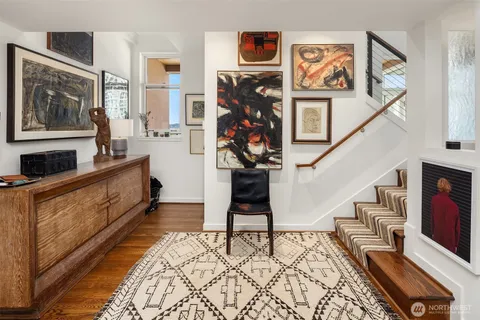 a living room with furniture a flat screen tv and a bookshelf