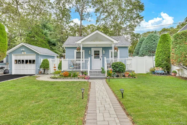 a front view of house with yard and green space