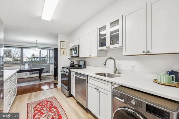 a kitchen with stainless steel appliances granite countertop a stove and a sink