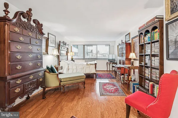 a living room with furniture and a book shelf