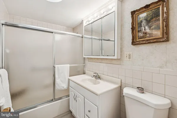 a bathroom with a sink and mirror with toilet