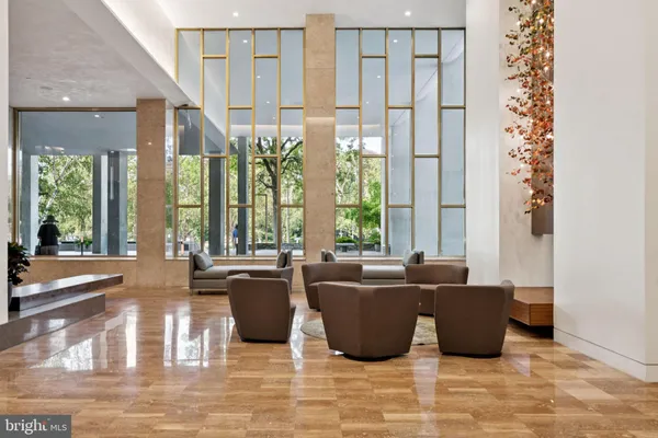 a living room with furniture and large windows