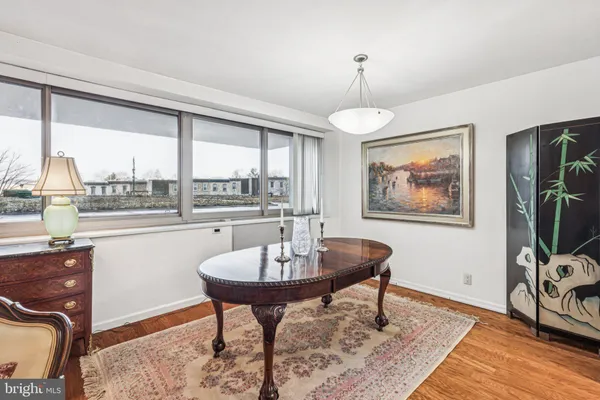 a living room with furniture a window and a chandelier