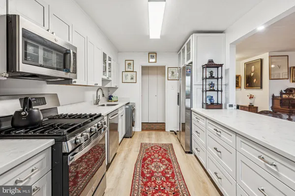 a kitchen with stainless steel appliances granite countertop a stove and a sink