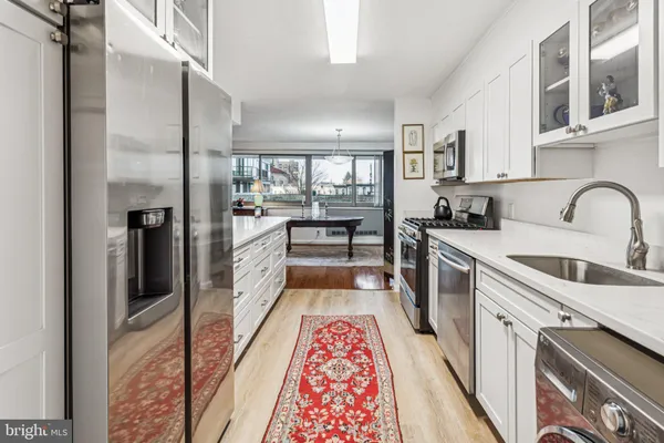 a kitchen with a sink stove and refrigerator